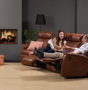 8 Easy Ways to Make Your Living Room Cozier A person sitting in a living room Description automatically generated