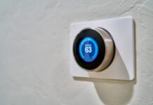 The Best Heaters for an Office Conversion gray Nest thermostat displaying at 63