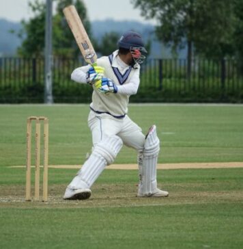 The Most Handsome Cricket Players In The World baseball player in white and blue jersey shirt and white pants holding baseball bat during daytime