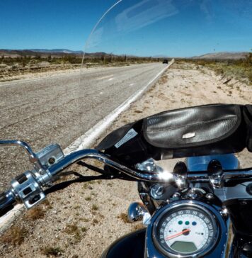 How a Motorcycle Accident Lawyer Can Help You Get Compensation touring motorcycle beside farm road