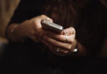 Online Sports Betting: A Beginner’s Guide to Getting Started person using smartphone