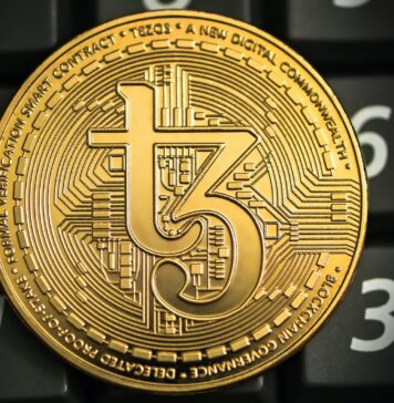 Unraveling the Acronym: What Does USDT Stand For? a gold coin sitting on top of a computer keyboard