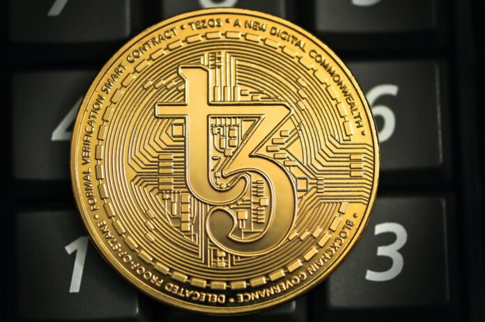 a gold coin sitting on top of a computer keyboard