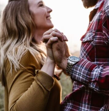 What Specific Premium Features Do Interracial Dating Sites Offer: Beyond the Norm of Online Dating woman in front of man holding each hands each other near green trees