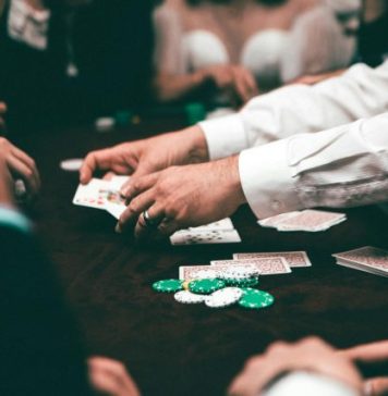 The Rise of Live Dealer Games An intense poker game featuring players and poker chips on the table in an indoor setting.