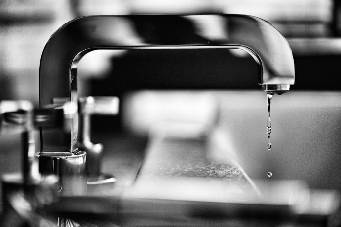 Photo by PAN XIAOZHEN grayscale photography of faucet